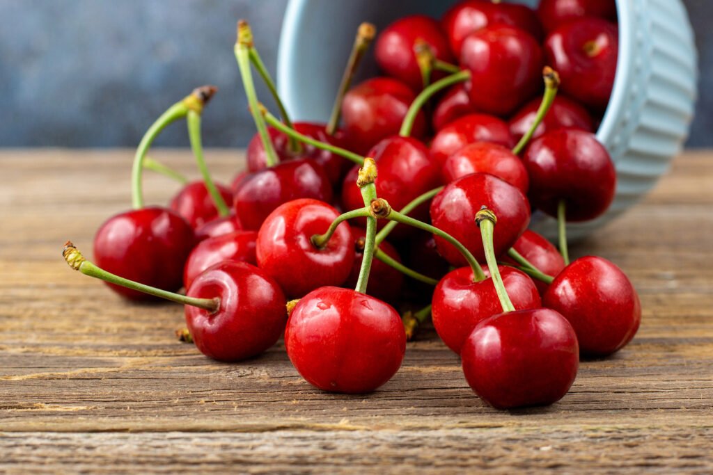 Ripe,Wet,Sweet,Cherries,Are,Poured,Out,Of,The,Blue