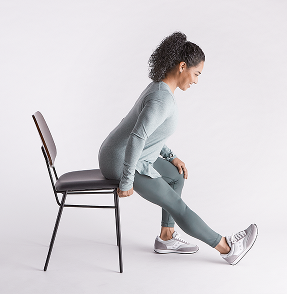 woman-sitting-in-chair-stretching-her-leg